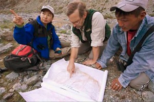 leaning over the map